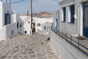 Stoned traditional alley at Paros island in Greece in the morning.