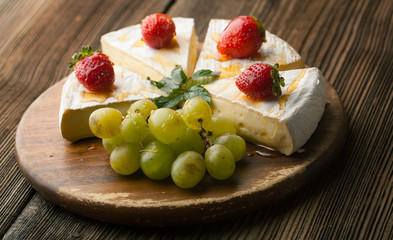 Brie cheese with strawberries and honey