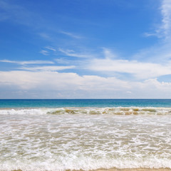 ocean, sandy beach and blue sky