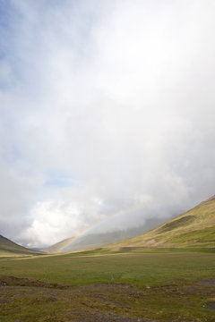 Rainbow over tundra landscape