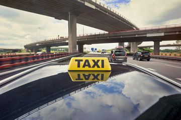 Taxi driving on a motorway intersection with flyover
