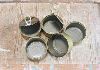 empty tin food can on wooden board