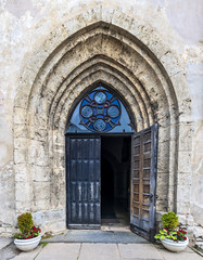 Fototapeta na wymiar Entrance to the medieval church, Europe 