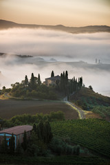 Beautiful foggy landscape in the middle sunrise. Italy, Tuscany.