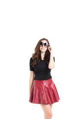 Young beautiful woman in sunglasses and red skirt.