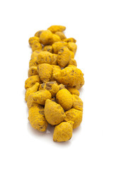 Row of Organic Round Turmeric or Haldi (Curcuma longa) isolated on white background.