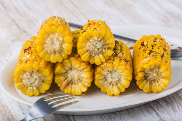 Roasted sweet corn on the cob on white plate © aneta_gu
