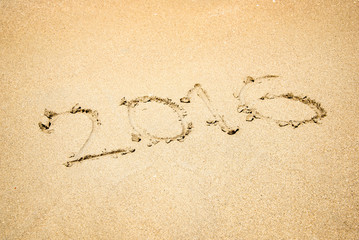 2016 written in the sand of a beach