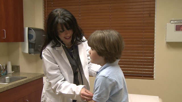 Female nurse checks child's breathing