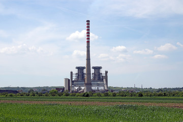 Fototapeta na wymiar thermal power plant on green wheat field industry