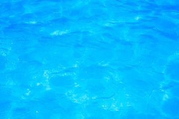 Blue pool water with sun reflections
