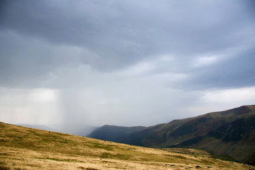 Fototapeta na wymiar Mystical landscape with rain clouds high in the mountains. Carpa
