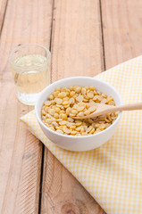 Healthy golden soil oil with a cup of raw soybean