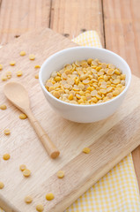 Healthy golden soil oil with a cup of raw soybean