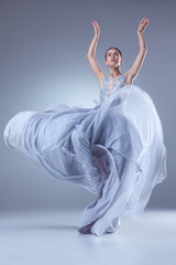 Fototapeta na wymiar The beautiful ballerina dancing in blue long dress 