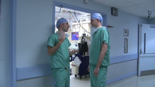 Surgeons finish a conversation and part ways