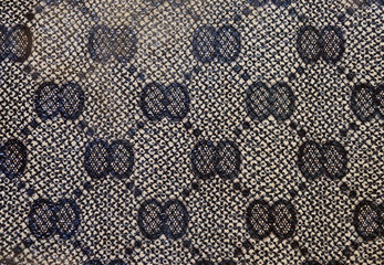 The photo shows  the original  black background with texture and with a geometric pattern of natural skin of animal origin