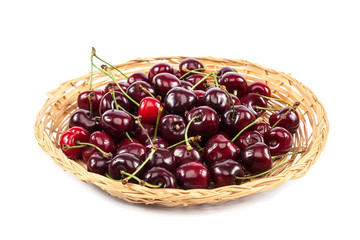 Fruits of sweet cherries in a wicker plate.