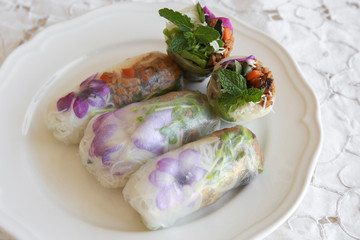 Homemade rice paper rolls with edible flowers
