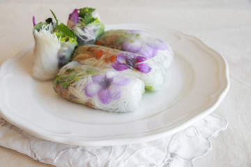 Homemade rice paper rolls with edible flowers