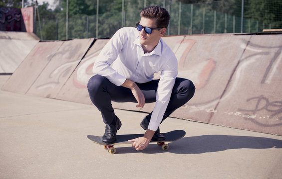 business man enjoying skateboard