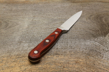 kitchen knife on wooden surface