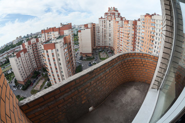 View from the balcony of a high-rise apartment building in the complex of brick monolit - obrazy, fototapety, plakaty
