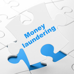 Currency concept: Money Laundering on puzzle background