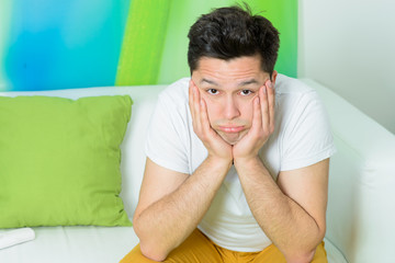 young man tired sitting at sofa