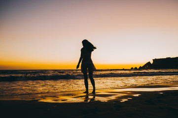 Sea beach girl silhouette, sunset
