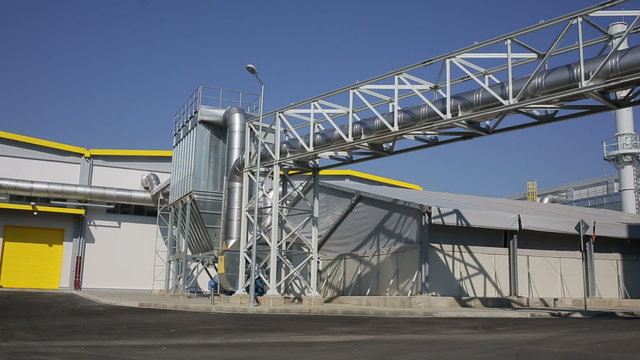 New modern industrial waste plant pipelines from the outside. Waste-to-energy plant. Produces a combustible fuel commodity, such as methane, methanol, ethanol and synthetic fuels.