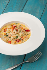 Seafood saute on the cyan wooden table