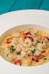 Seafood saute on the cyan wooden table close-up