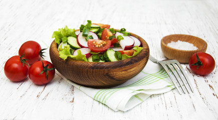 Spring salad with tomato, cucumbers and radish