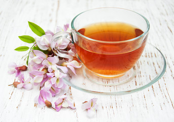 Cup of tea and acacia flowers