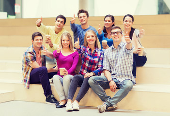 group of smiling students with paper coffee cups