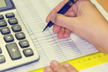 Photo of hand making notes with pen