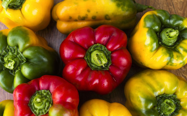 Bright, colorful, beautiful, ripe peppers on a wooden background