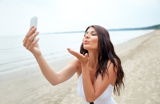 young woman taking selfie with smartphone