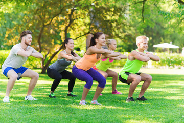 group of friends or sportsmen exercising outdoors