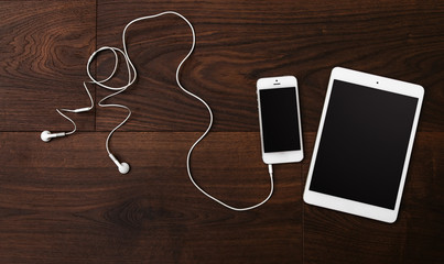 Smartphone and tablet with earphones © blackday