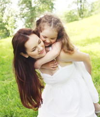 Fototapeta premium Happy mother and child having fun together in summer park