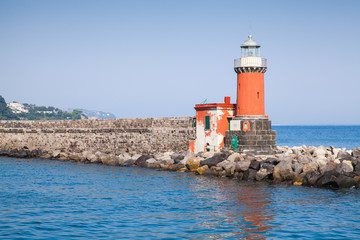 Red lighthouse tower, entrance of Ischia Porto