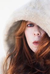 Red head woman with white hood.