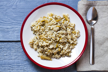 a plate of rice with green beans, top view