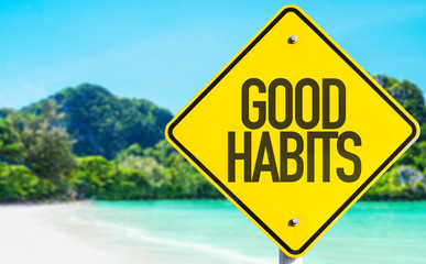 Good Habits sign with beach background