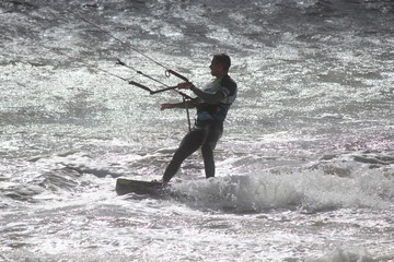 Man in Wetsuit Surfing, Using Parachute to give Speed, Momentum and Lift. England, September 2015.