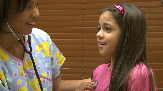 Nurse checks young girl's lungs