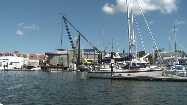 Crane at marina and moored boats.