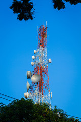 telecommunication tower and cloudy blue sky with foreground of p